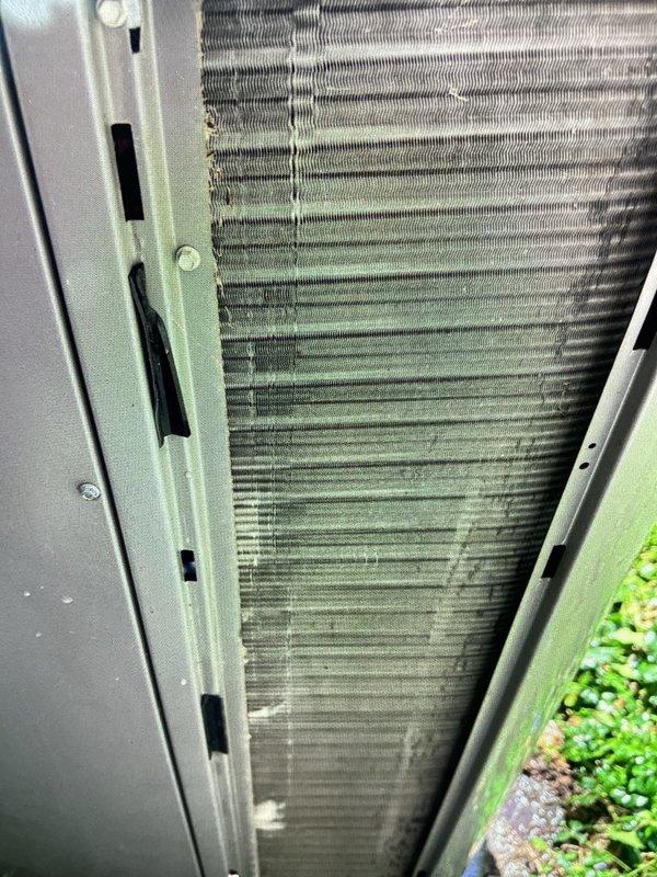 Performed comprehensive annual maintenance on a 10-year-old central air conditioning system. Upon inspection, discovered heavily soiled air filter with significant dirt and dust accumulation restricting airflow, which was replaced with new filter. Condenser coil exhibited substantial debris buildup with dirt and dust clogging aluminum fins throughout upper and middle sections. Cleaned condenser coil thoroughly to restore proper airflow and heat transfer efficiency. Verified system operation following maintenance procedures, confirming unit is functioning properly with improved airflow and performance.