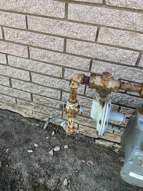 Conducted on-site consultation for whole house generator installation at a 60-year-old residential property. Assessed existing electrical service panel in basement utility area and evaluated outdoor utility connections including gas meter and plumbing infrastructure mounted on exterior brick wall. Provided recommendations on appropriate Kohler generator sizing based on home's electrical load requirements and existing service capacity.