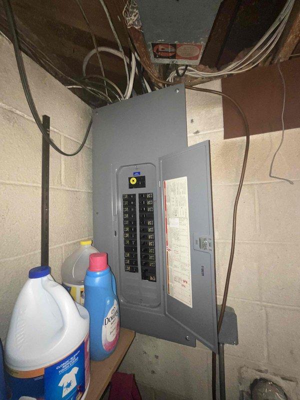 Conducted on-site consultation for whole house generator installation at a 60-year-old residential property. Assessed existing electrical service panel in basement utility area and evaluated outdoor utility connections including gas meter and plumbing infrastructure mounted on exterior brick wall. Provided recommendations on appropriate Kohler generator sizing based on home's electrical load requirements and existing service capacity.