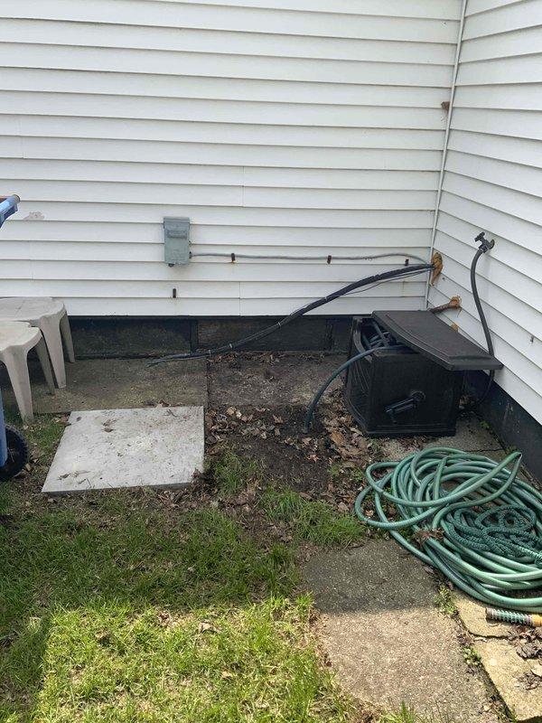 Conducted on-site evaluation for central air conditioning system installation at residence currently without cooling capabilities. Assessed existing HVAC infrastructure including furnace/air handler unit located in utility room and evaluated exterior placement options for condenser unit. Documented current equipment configuration, available electrical service, ductwork condition, and proposed exterior condenser location near existing utility area with concrete pad accessibility.