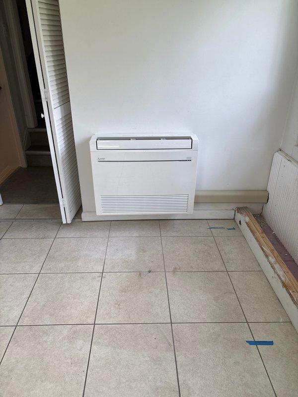 Successfully completed installation of Mitsubishi ductless mini-split heat pump system. Installed Mitsubishi SUZ-AA12NLHZ outdoor condenser unit on composite pad as requested by customer and floor-mounted indoor air handler unit in interior room with beige tile flooring. Ran refrigerant lines and established connections between indoor and outdoor components. Installed new dedicated electrical circuit to power the system, meeting all electrical code requirements. Secured all necessary permits including mechanical, electrical, and mini-split specific permits prior to installation. System is factory-charged with A2L refrigerant and rated for 208/230V, single-phase, 60Hz operation with IPX4 protection rating. Verified all AHRI certifications and ETL Intertek compliance markings. Tested system operation to ensure proper heating and cooling functionality. All components installed per manufacturer specifications and local building codes.