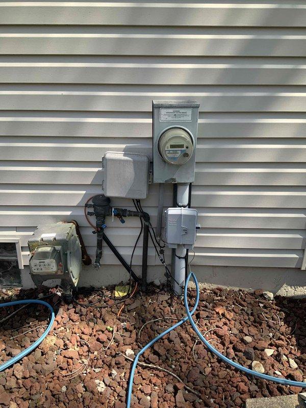 Conducted comprehensive site evaluation for Generac generator installation at residential property with no existing backup power system. Documented property layout including measurements and optimal placement locations, assessed current electrical service entrance and metering configuration, and photographed existing utility infrastructure to determine connection requirements and necessary materials for complete standby generator system installation.