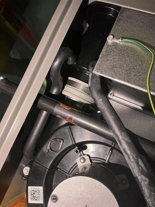 Responded to callback for condensate leak causing cabinet corrosion. Upon inspection, discovered significant rust damage to cabinet plate near vent area due to moisture intrusion from condensate drainage issue. Documented extensive corrosion on orange mounting platform and metal piping components within the air handler cabinet. Photographed affected areas showing oxidation on cabinet surfaces and blower assembly mounting hardware for warranty documentation and future reference.