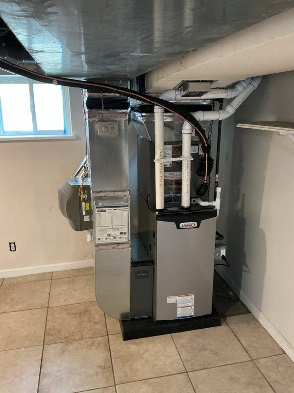 Completed full HVAC system installation in basement mechanical room, including 70,000 BTU Lennox furnace and 2-ton air conditioning unit with rear discharge configuration. Installed new ductwork with metallic insulation, refrigerant lines, and white PVC venting system. Reconnected humidifier to new furnace, mounted expansion tank, and installed equipment on protective base pads. Secured all electrical connections, completed refrigerant line installation with proper mounting straps, and ensured all condensate drainage systems were properly configured. Permits were obtained for mechanical, refrigeration, and furnace work prior to installation.