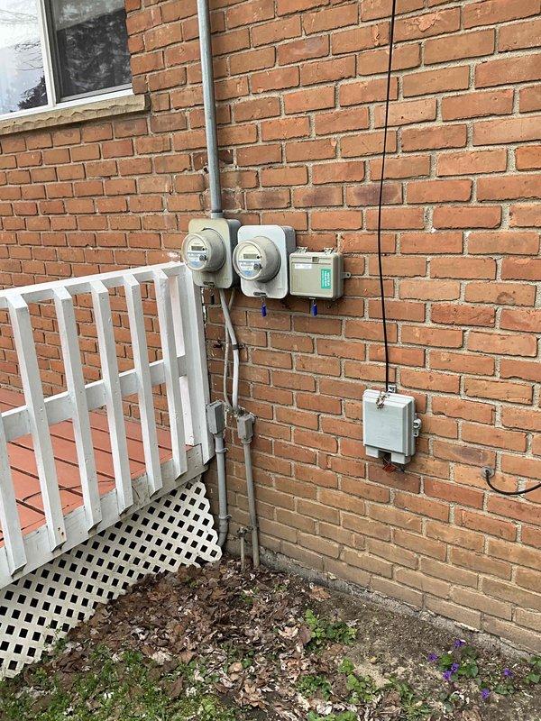 Conducted comprehensive on-site evaluation for air conditioning system replacement at residential property. Assessed existing HVAC equipment including indoor air handler unit located in basement utility area and outdoor condensing unit mounted on exterior brick wall. Documented current system configuration, electrical service connections with dual meter setup, and ductwork routing through basement mechanical room. Photographed equipment installations to provide detailed visual reference for replacement planning and equipment sizing recommendations. Discussed replacement options with customer to determine appropriate system specifications based on home requirements and existing infrastructure.