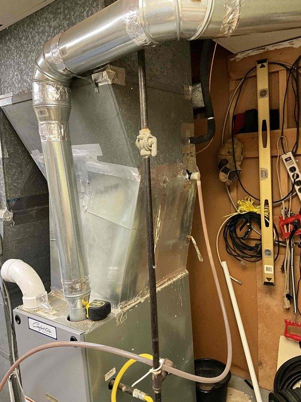 Conducted comprehensive on-site evaluation for air conditioning system replacement at residential property. Assessed existing HVAC equipment including indoor air handler unit located in basement utility area and outdoor condensing unit mounted on exterior brick wall. Documented current system configuration, electrical service connections with dual meter setup, and ductwork routing through basement mechanical room. Photographed equipment installations to provide detailed visual reference for replacement planning and equipment sizing recommendations. Discussed replacement options with customer to determine appropriate system specifications based on home requirements and existing infrastructure.