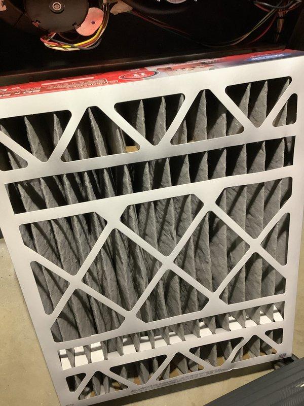 Completed annual HVAC maintenance inspection and filter evaluation. Documented existing filter conditions, including one heavily soiled filter with significant dust and debris accumulation requiring replacement, and one clean filter in acceptable condition. Photographed equipment components and filter status for maintenance records.