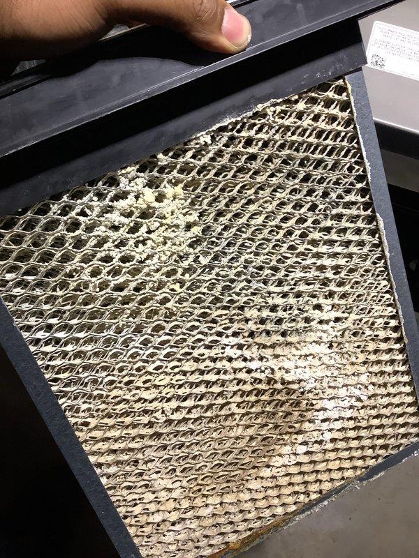 Completed annual HVAC maintenance inspection and filter evaluation. Documented existing filter conditions, including one heavily soiled filter with significant dust and debris accumulation requiring replacement, and one clean filter in acceptable condition. Photographed equipment components and filter status for maintenance records.