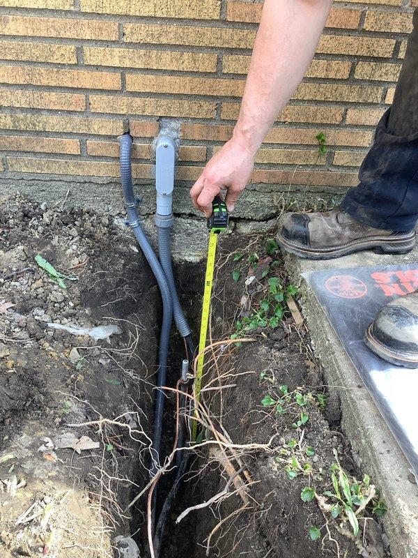 Completed electrical recall work for HVAC installation to bring system into code compliance. Installed equipment grounding conductor (EGC) and ground rod for sub panel, disconnecting improper grounding from water pipe. Installed underground feeder conductors to sub panel and AC feed to proper burial depth in excavated trench alongside building foundation. Removed obsolete electrical wiring from garage. Upgraded garage electrical outlets to GFCI protection and installed one additional general-purpose GFCI-protected outlet in garage per code requirements.