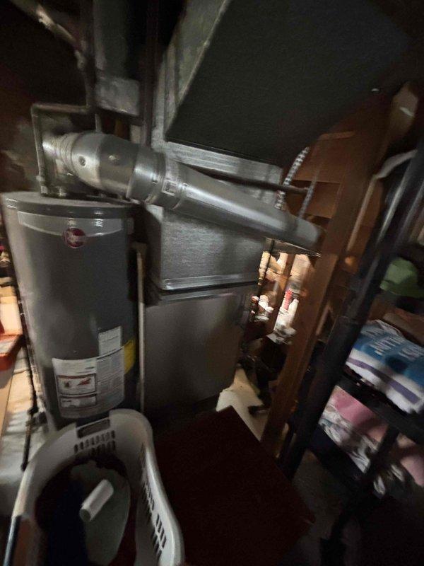 Conducted comprehensive site assessment for complete HVAC system replacement estimate including new air conditioning unit and natural gas furnace located in basement. Evaluated existing 10-year-old furnace, documented equipment dimensions and clearances, assessed ductwork configuration, and photographed current mechanical room layout including water heater proximity and copper piping infrastructure to determine optimal replacement equipment specifications and installation requirements.