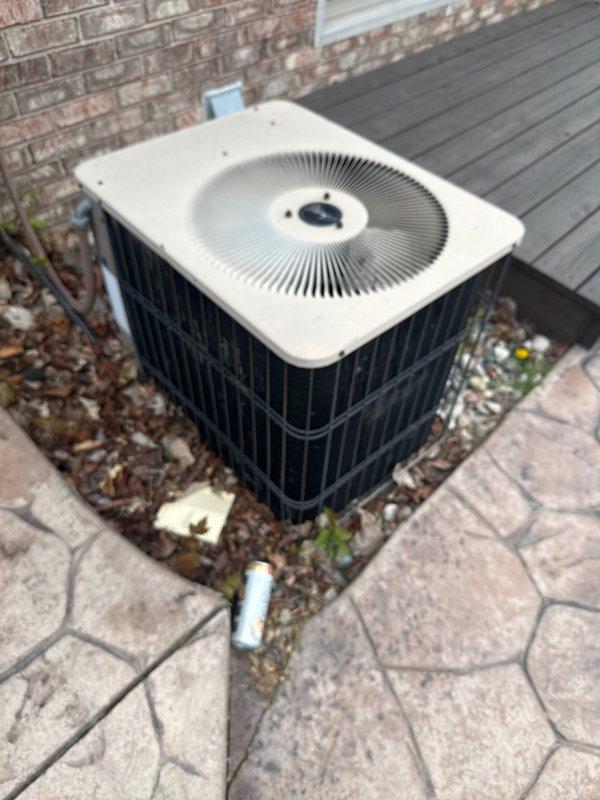 Completed annual cooling maintenance on residential air conditioning system. Performed comprehensive inspection of outdoor condenser unit, verified proper operation of fan motor and compressor, checked refrigerant levels, and cleaned debris from around unit base and stone paver area. Documented equipment condition with photos showing normal weathering and standard operating status for outdoor installation.