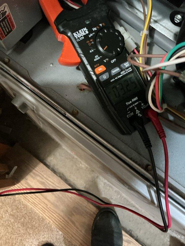 Completed annual HVAC maintenance on Carrier system, performing electrical diagnostics with multimeter to verify proper voltage and component operation at indoor air handler unit. Inspected outdoor condenser unit, noting cooling fins in acceptable condition with minor dust accumulation typical of normal operation, and confirmed filter replacement needed per maintenance schedule.