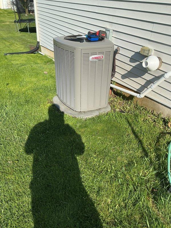 Completed comprehensive AC tune-up on 2-year-old Lennox condenser unit. Performed standard maintenance protocol including refrigerant pressure checks using manifold gauges, inspected electrical connections, verified proper operation of compressor and condenser fan motor, cleaned condenser coils, and confirmed adequate airflow through unit. System operating within normal parameters with no deficiencies noted; condensate drain line clear and functioning properly.