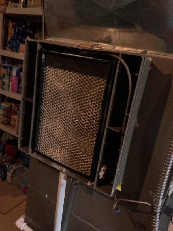 Completed annual cooling maintenance on residential HVAC system. Inspected and photographed furnace unit with internal heat exchanger showing normal dust accumulation on honeycomb filter element. Verified Lennox smart thermostat operation with system maintaining 68°F heating setpoint and 85°F cooling setpoint, displaying proper humidity reading of 42%. All equipment operating within normal parameters with no deficiencies noted.