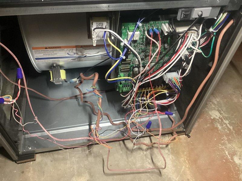 Responded to service call for cooling system malfunction. Performed diagnostic inspection of HVAC unit by accessing control panel and examining internal components. Inspected circuit boards, electrical connections, and wiring throughout the system. Observed multiple wire connections and control board assembly for signs of failure or damage. Measured supply air temperature at 55°F using digital thermometer to verify system output. Examined refrigerant lines and copper tubing connections in lower cabinet section. Documented current system conditions with photographs for diagnostic reference. System requires further troubleshooting to isolate root cause of cooling issue and determine necessary repairs.
