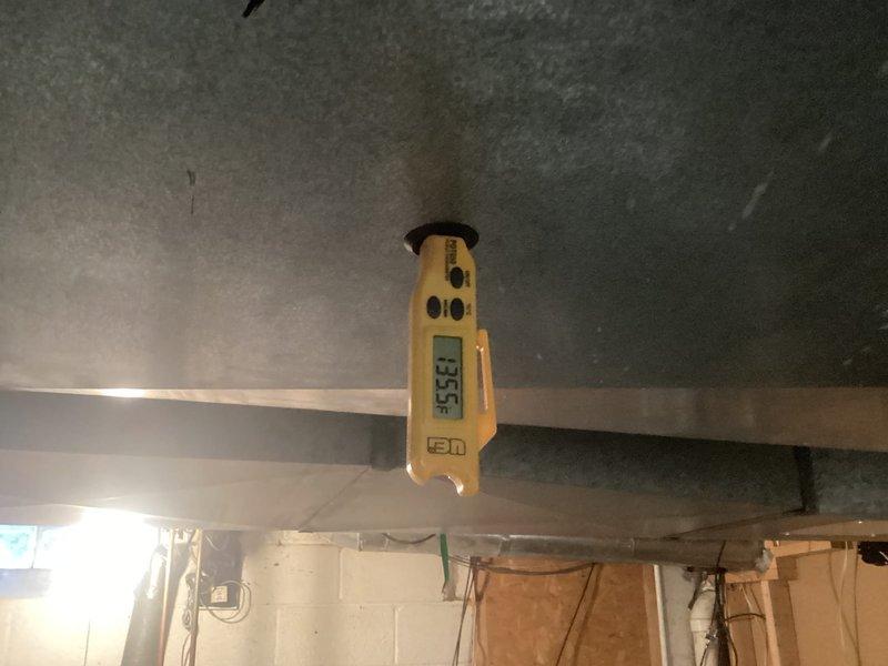 Responded to service call for cooling system malfunction. Performed diagnostic inspection of HVAC unit by accessing control panel and examining internal components. Inspected circuit boards, electrical connections, and wiring throughout the system. Observed multiple wire connections and control board assembly for signs of failure or damage. Measured supply air temperature at 55°F using digital thermometer to verify system output. Examined refrigerant lines and copper tubing connections in lower cabinet section. Documented current system conditions with photographs for diagnostic reference. System requires further troubleshooting to isolate root cause of cooling issue and determine necessary repairs.