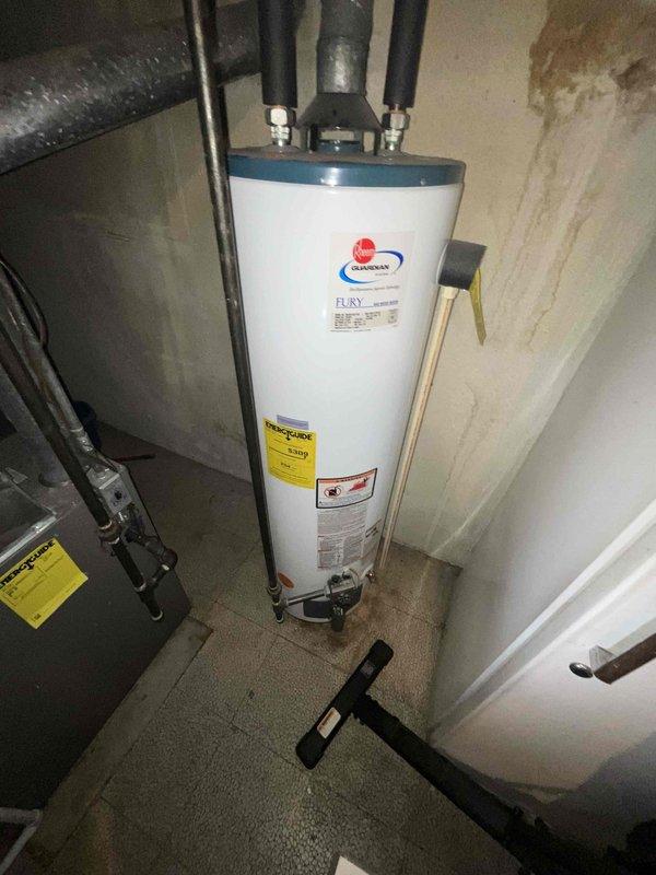Conducted on-site evaluation of 13-year-old residential air conditioning system to provide replacement estimate. Documented existing HVAC equipment configuration in basement mechanical room, including current furnace unit, ductwork layout, and system connections. Assessed accessibility for equipment removal and new installation, noting concrete floor workspace, overhead joist clearances, and stairwell access considerations for equipment delivery.