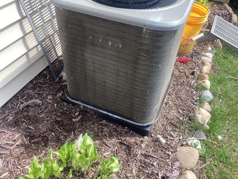 Completed comprehensive 5-year recurring ComfortGuard maintenance visit on residential outdoor HVAC system. Performed thorough inspection and cleaning of air conditioning condenser unit, which exhibited significant accumulation of dirt, grime, and debris on exterior surfaces. Cleaned condenser coils, removed cobwebs and environmental buildup from unit housing and components. Verified proper operation of condenser fan and assessed overall system condition. Inspected installation site including base pad stability, clearances, and surrounding drainage components. Unit returned to optimal operating condition following maintenance protocol.