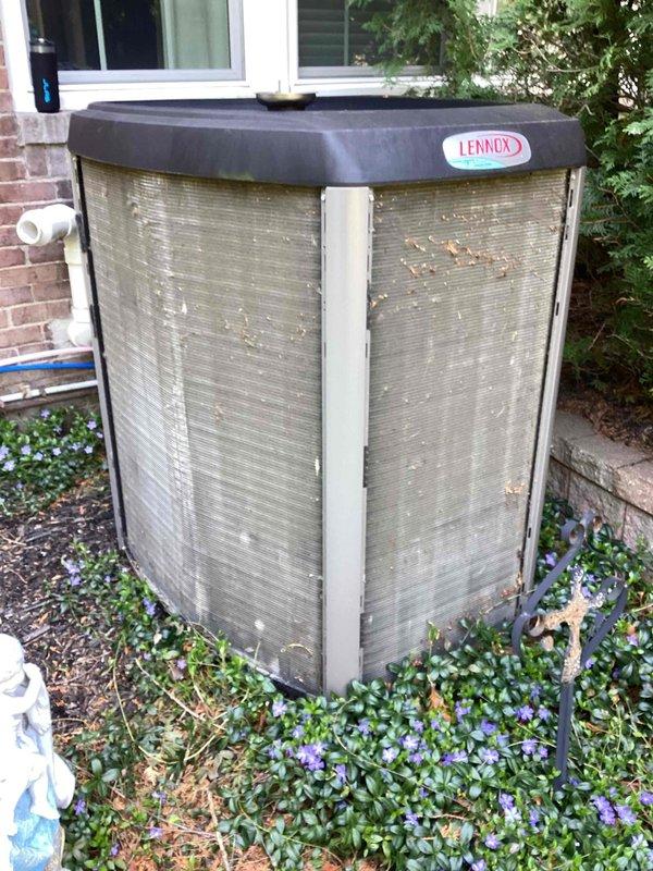 Completed annual recurring maintenance on residential Lennox air conditioning condenser unit and generator system. Performed comprehensive ACM (Air Conditioning Maintenance) inspection and service procedures. Conducted thorough visual assessment of outdoor condenser unit, noting accumulated environmental debris, leaves, and organic matter on metal grille panels and fins. Cleaned exterior surfaces and removed debris from unit to ensure proper airflow and heat exchange efficiency. Inspected manufacturer badge, protective top cover, corner posts, and metal louver panels for physical condition and weathering. Verified unit positioning on concrete pad and checked surrounding landscape clearance. Applied generator maintenance procedures using maintenance kit as specified. Evaluated overall system operation and confirmed equipment functionality. Unit shows typical outdoor exposure with minor weathering but remains in serviceable condition. All maintenance tasks completed per annual service pr