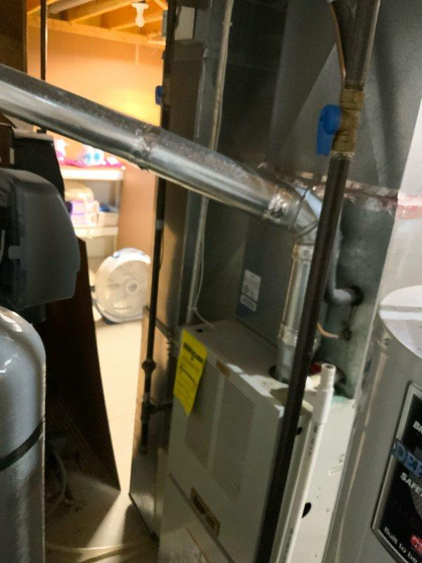 Conducted on-site assessment for air conditioning system replacement estimate. Evaluated existing HVAC equipment including indoor air handler/furnace unit located in basement mechanical room and outdoor condenser unit with associated refrigerant lines and electrical disconnect. Documented current system configuration, equipment condition, and installation setup. Photographed both indoor and outdoor components to provide comprehensive system evaluation for replacement options.