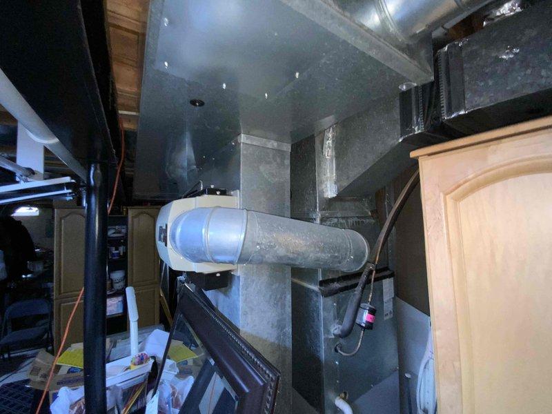 Conducted on-site evaluation of 11-year-old furnace and air conditioning system for replacement estimate. Inspected existing HVAC equipment in basement utility area, including air handler unit, ductwork connections, and associated mechanical components. Documented current system configuration and provided replacement options for both heating and cooling units to customer considering summer installation.