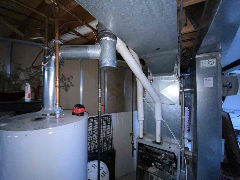 Conducted on-site evaluation of 11-year-old furnace and air conditioning system for replacement estimate. Inspected existing HVAC equipment in basement utility area, including air handler unit, ductwork connections, and associated mechanical components. Documented current system configuration and provided replacement options for both heating and cooling units to customer considering summer installation.
