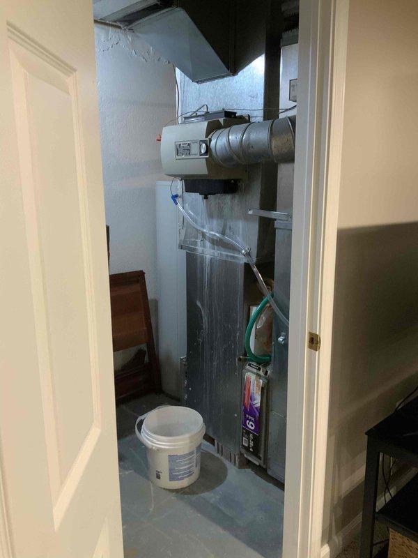 Conducted comprehensive evaluation of existing 15-25 year old natural gas furnace and air conditioning system located in basement mechanical closet. Assessed current equipment operation, ductwork configuration, and available space for replacement units. Documented existing HVAC installation including horizontal blower assembly, air handling components, and condensate management system. Provided detailed replacement estimate for new furnace and A/C system to improve efficiency and reliability.