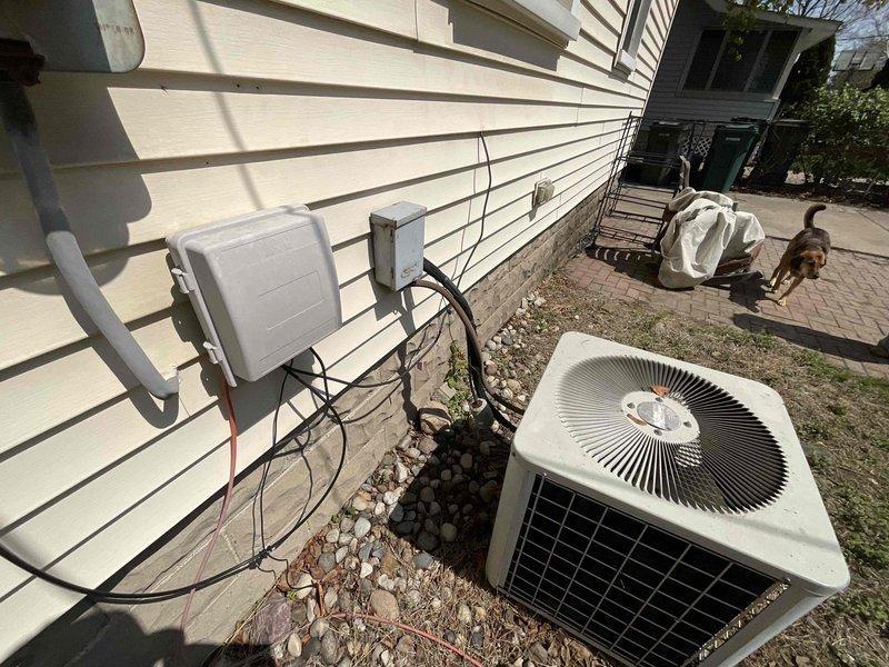 Provided estimate for complete HVAC system replacement including natural gas furnace and air conditioning unit for 30-year-old equipment located in basement mechanical room. Current air conditioning system non-operational while furnace remains functional. Assessed existing ductwork configuration, electrical disconnects, and outdoor condenser placement on decorative rock bed adjacent to home exterior with vinyl siding.