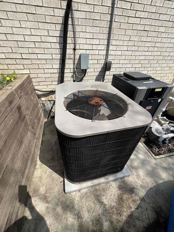 Provided estimate for complete replacement of 18-year-old non-operational furnace and air conditioning system currently located in basement. Evaluated existing outdoor condenser unit and associated refrigerant lines running along exterior brick wall, noting equipment positioned on concrete pad with electrical disconnect box and conduit routing. Assessed installation requirements for new HVAC system to restore heating and cooling functionality to the residence.