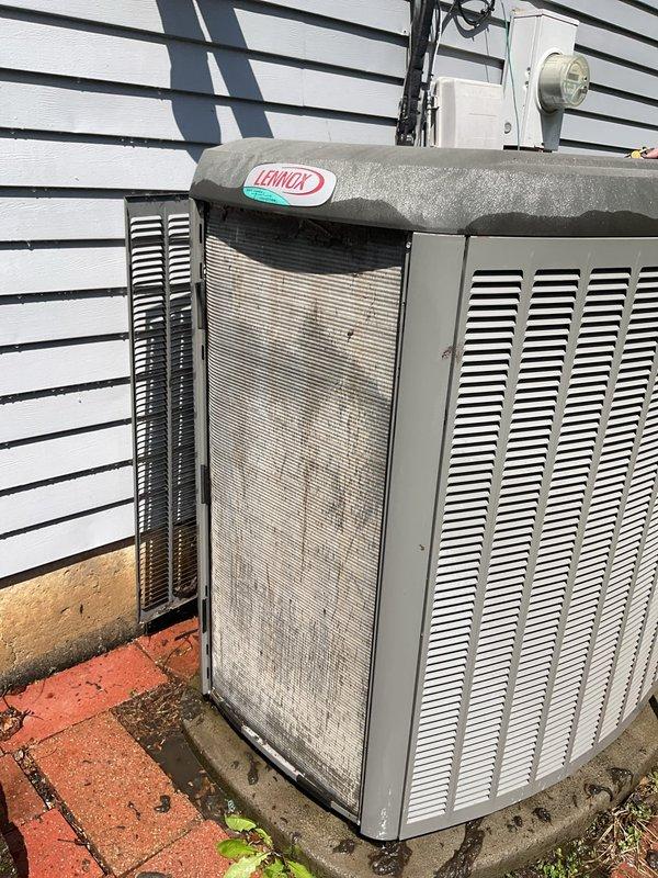 Responded to service call for Lennox air conditioning system displaying error code 411 and non-functional humidifier. Upon arrival, performed diagnostic assessment of outdoor condensing unit which showed signs of age and debris accumulation on coil surfaces and ventilation grilles. Connected Fieldpiece SMAN refrigerant manifold and vacuum gauge to system to evaluate refrigerant pressures and temperatures. Diagnostic readings indicated low-side temperature of 102°F and high-side temperature of 403°F with associated pressure values. Assessed overall system performance and identified maintenance needs including cleaning of condenser coil and filtration components. Documented equipment condition through photography showing weathered exterior cabinet, dirt buildup on mesh screens, and general need for preventive maintenance. Evaluated humidifier integration with HVAC system to address reported malfunction. Provided technical findings and recommendations for restoring proper operation of bot