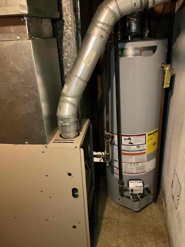 Completed full system estimate for residential HVAC replacement. Inspected and photographed existing 19-year-old outdoor condenser unit showing signs of weathering, rust accumulation, and poor maintenance with vegetation growth around base. Evaluated indoor furnace and ductwork installation in basement utility area. Provided comprehensive replacement options for complete heating and cooling system, as current equipment is approaching end of service life though still operational.