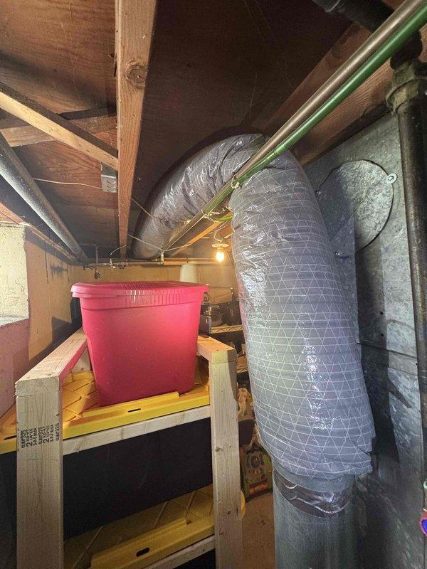 Conducted comprehensive full system evaluation for 16-year-old HVAC equipment located in basement with distribution through attic space. Assessed existing furnace showing signs of condensation on exterior surfaces, inspected flexible ductwork installation throughout attic crawl space including insulated silver flex ducts wrapped around structural supports, and evaluated overall system condition including copper refrigerant lines and air distribution components. Provided complete replacement system estimate with recommendations for immediate installation based on equipment age and current operating condition.