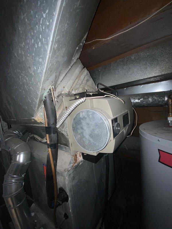 Completed on-site assessment for air conditioning system replacement estimate. Existing AC unit confirmed to be over 15 years old and requiring full replacement due to age and declining performance. Documented current HVAC equipment configuration including Lennox furnace installation in utility closet with connected ductwork and plenum, as well as basement air handling components with flexible ducting. Photographed existing system layout to support replacement proposal and equipment specifications.