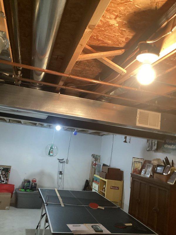Completed full HVAC system installation in basement mechanical room including new Lennox 70,000 BTU furnace with humidifier and 2-ton air conditioning unit with rear discharge configuration. Installed all necessary metallic ductwork connections with proper sealing at joints and reconnected existing utility infrastructure to new equipment. All mechanical permits obtained prior to installation, system tested and operational upon completion.