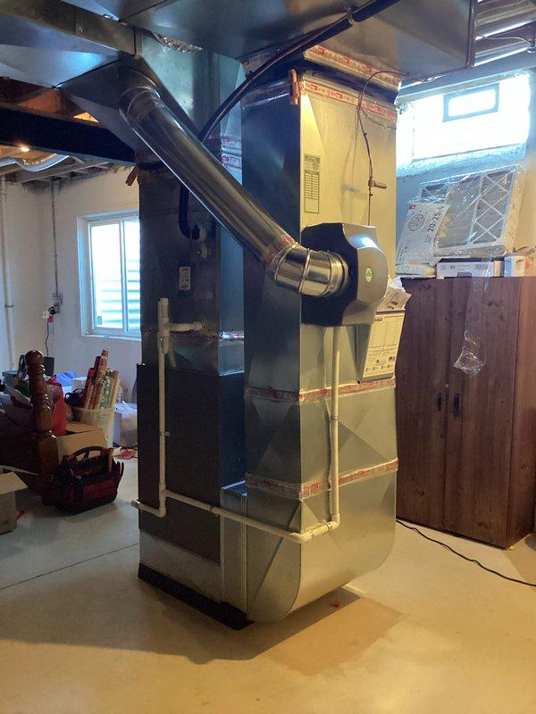 Completed furnace-only installation of a 135,000 BTU high-efficiency unit in basement mechanical room. Installation included proper venting with PVC intake and exhaust piping, electrical and gas reconnection, and humidifier integration with existing ductwork. All mechanical and electrical permits obtained, system tested and operational upon completion.