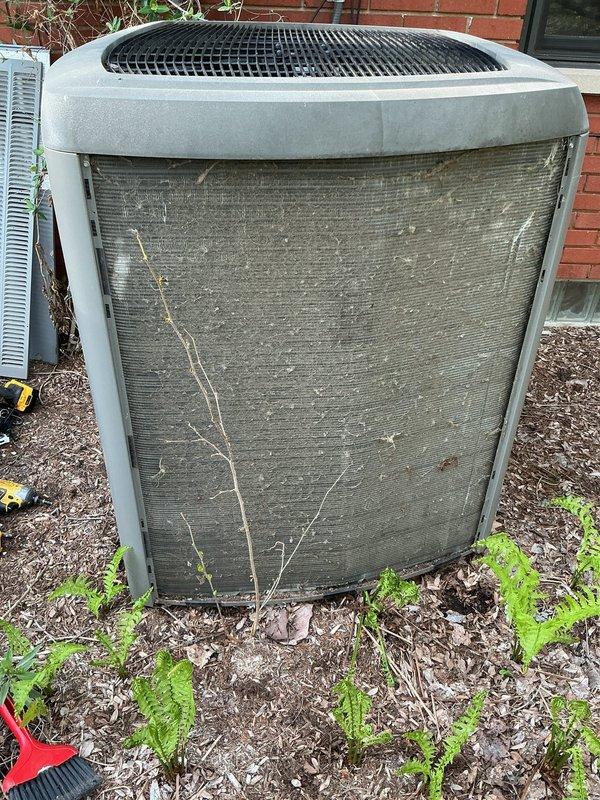 Completed annual cooling maintenance on outdoor condensing unit. Upon arrival, found cooling fins heavily soiled with accumulated dirt, dust, debris, and plant material including branches and twigs lodged against coil surfaces. Cleaned condenser coils thoroughly to restore proper airflow and heat transfer efficiency. Removed vegetation, sticks, and organic debris from unit exterior and surrounding area. Performed standard ACM protocol including system inspection, operational testing, and documentation with photos. Unit returned to proper operating condition with improved airflow through heat exchanger.