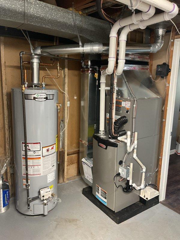 Completed full HVAC system installation including a 70,000 BTU furnace and 2-ton air conditioning unit in basement utility area. Installed new electrical circuit to support equipment, ran condensate drain lines with white PVC piping, and connected insulated ductwork throughout the system. Positioned furnace on protective pad adjacent to existing water heater with proper clearances for maintenance access. Secured all ductwork to ceiling joists with appropriate hangers, completed electrical connections, and verified all mechanical and electrical components operational. Obtained necessary mechanical and electrical permits prior to installation. All equipment tested and functioning within manufacturer specifications upon completion.