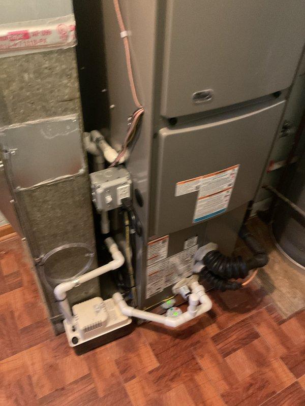 Completed full HVAC system installation including a 70,000 BTU furnace and 2-ton air conditioning unit in residential utility room. Installed new electrical circuit to support equipment, ran white PVC venting from furnace through ceiling, connected copper refrigerant lines between indoor and outdoor units, and installed condensate pump with drainage system. Obtained mechanical and electrical permits prior to installation, positioned furnace with proper clearances adjacent to existing water heater, secured all ductwork connections with insulated flex duct, and verified all gas line connections, electrical wiring, and system controls for safe operation.