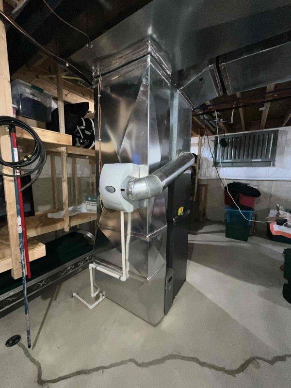 Conducted full system evaluation for HVAC replacement estimate in response to recurring refrigerant leak requiring annual recharging. Inspected existing furnace and air conditioning system, documented current equipment condition including furnace interior components, blower assembly, burner configuration, and ductwork connections. Provided comprehensive replacement options focused primarily on air conditioning unit replacement to address chronic refrigerant loss issue.