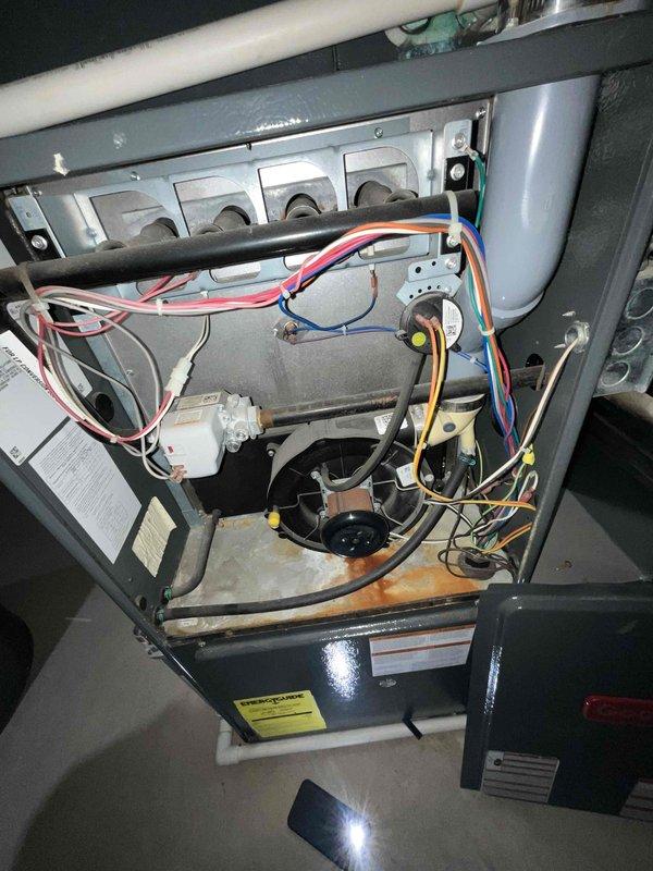 Conducted full system evaluation for HVAC replacement estimate in response to recurring refrigerant leak requiring annual recharging. Inspected existing furnace and air conditioning system, documented current equipment condition including furnace interior components, blower assembly, burner configuration, and ductwork connections. Provided comprehensive replacement options focused primarily on air conditioning unit replacement to address chronic refrigerant loss issue.