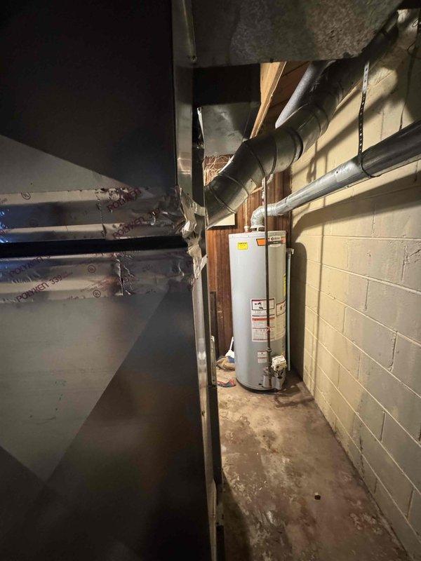 Provided comprehensive estimate for complete HVAC system replacement in basement mechanical room where existing air conditioning unit is non-operational. Assessed installation requirements for new AC system compatible with existing natural gas furnace, evaluated basement utility area layout including clearances around water heater and ductwork configuration, and documented exterior condensing unit placement options along brick exterior wall near existing electrical meter.