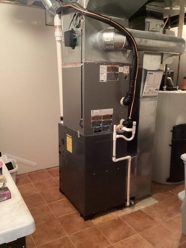 Completed full installation of 4-ton air conditioning system with matching evaporator coil. Obtained mechanical and electrical permits prior to installation. Installed new outdoor condensing unit with right-side refrigerant line configuration, connected copper refrigerant lines to indoor evaporator coil mounted above existing furnace, and established proper refrigerant circuit. Completed all electrical reconnections to power the new AC system. Installed PVC condensate drain piping to handle moisture removal from the evaporator coil. Verified proper system operation, airflow, and refrigerant charge levels. All work performed to code requirements and manufacturer specifications. System tested and operational upon completion.