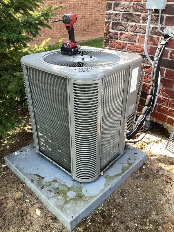 Completed annual cooling maintenance on residential outdoor condensing unit. Performed comprehensive system inspection including electrical connections, refrigerant lines, condensate drainage, and fan operation. Unit found in good operating condition with all components functioning properly. Cleaned condenser pad of debris and organic growth, verified proper airflow through louvers, and confirmed secure mounting of disconnect box and line set connections.