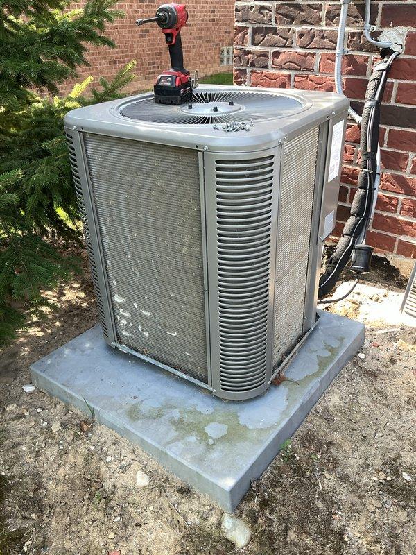 Completed annual cooling maintenance on residential outdoor condensing unit. Performed comprehensive system inspection including electrical connections, refrigerant lines, condensate drainage, and fan operation. Unit found in good operating condition with all components functioning properly. Cleaned condenser pad of debris and organic growth, verified proper airflow through louvers, and confirmed secure mounting of disconnect box and line set connections.