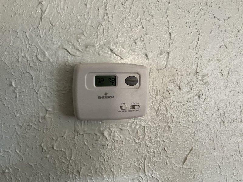 Completed annual HVAC maintenance on residential air conditioning system. Performed comprehensive inspection of outdoor condensing unit, verified thermostat operation displaying 73°F, and conducted electrical diagnostics using clamp meter to test voltage and amperage at capacitor and control board connections. All components found operating within normal parameters with no issues identified during routine maintenance check.