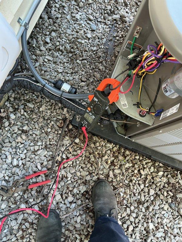 Completed annual HVAC maintenance on residential air conditioning system. Performed comprehensive inspection of outdoor condensing unit, verified thermostat operation displaying 73°F, and conducted electrical diagnostics using clamp meter to test voltage and amperage at capacitor and control board connections. All components found operating within normal parameters with no issues identified during routine maintenance check.