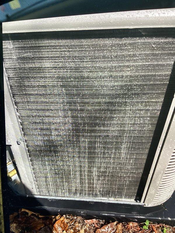 Completed annual cooling maintenance on residential HVAC system. Replaced air filter and humidifier pad as scheduled. Inspected furnace in response to reported popping noise during operation and verified system operation. Documented severely clogged condenser coil with extensive dirt, dust, and debris accumulation restricting airflow through fins. Noted organic material and leaves collected at base of outdoor unit. Condenser coil condition indicates reduced heat transfer efficiency and requires professional coil cleaning to restore optimal system performance.