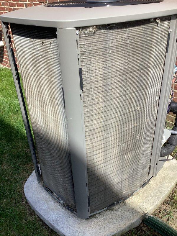Completed comprehensive 5-year ComfortGuard Maintenance visit on residential outdoor condensing unit. Performed standard maintenance protocol including inspection of cabinet, heat exchanger fins, and fan assembly. Addressed specialty service need by removing deteriorated caulking around refrigerant line penetration point and resealing piping entry from outdoor unit to interior with fresh weatherproof caulk to restore moisture barrier and prevent air infiltration. Unit operational and returned to service.