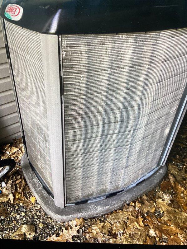 Completed annual preventive maintenance on residential air conditioning system. Inspected outdoor condenser unit, noting accumulation of dirt, dust, and debris on coil fins and exterior surfaces. Unit operational with normal wear consistent with outdoor exposure; all structural components and protective grilles intact and functioning properly.