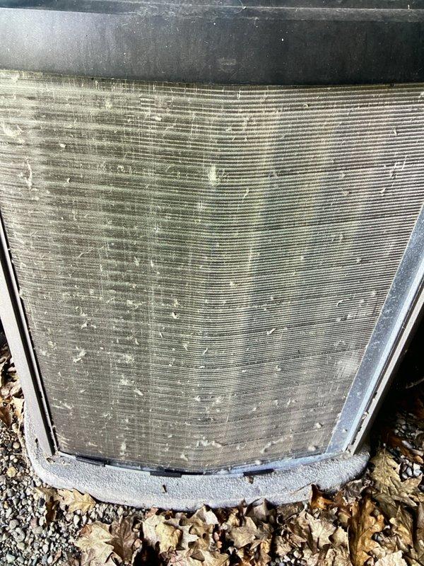 Completed annual preventive maintenance on residential air conditioning system. Inspected outdoor condenser unit, noting accumulation of dirt, dust, and debris on coil fins and exterior surfaces. Unit operational with normal wear consistent with outdoor exposure; all structural components and protective grilles intact and functioning properly.